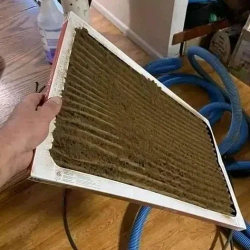 a air duct vent filled with brown dust
